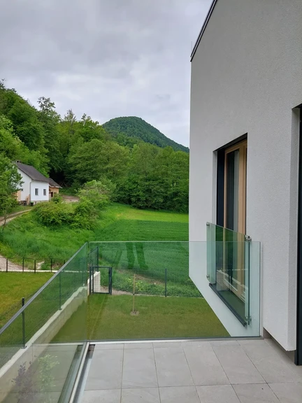 Prozorna steklena ograja na balkonu — kaljeno varnostno steklo. Ljubljana